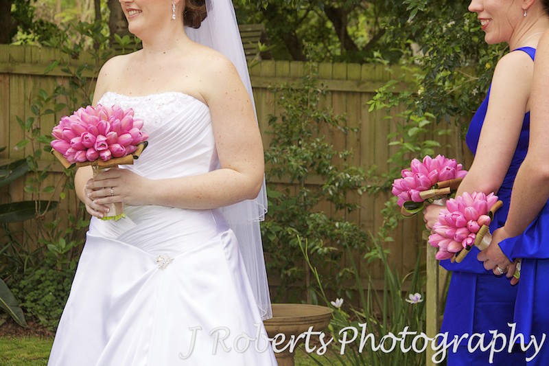 Bride and bridesmaids holding pink tulip bouquets - wedding photography sydney